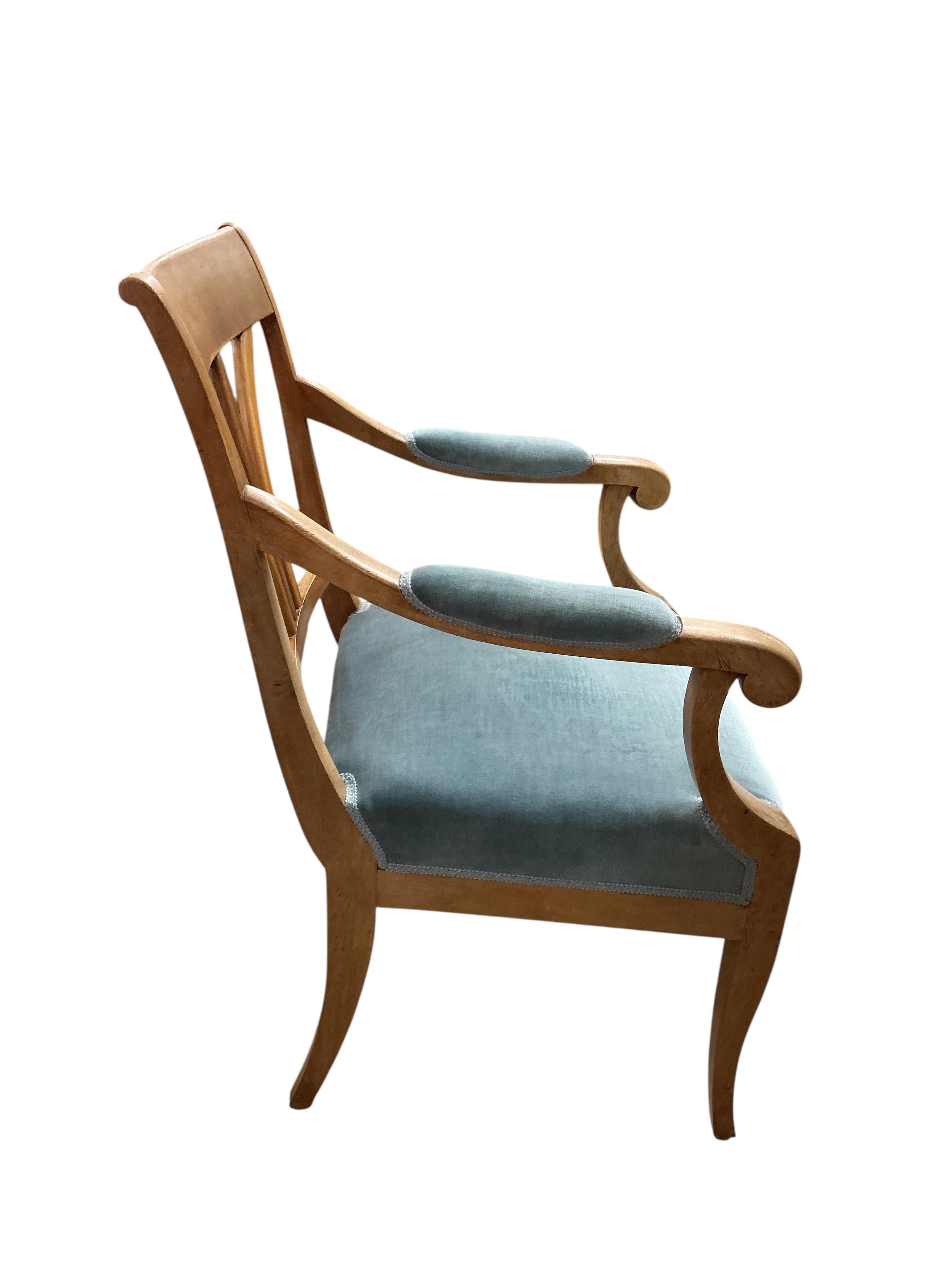 A Swedish circular walnut breakfast table, diameter 107cm, height 76cm together with four dining chairs, one with arms
